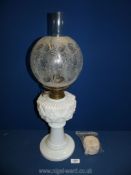 A double burner oil Lamp with opaque glass reservoir and etched glass shade, 23" high,