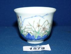 A reproduction Chinese porcelain 'Month' cup decorated with orchids,