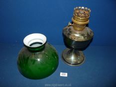 A metal Oil Lamp with green shade.