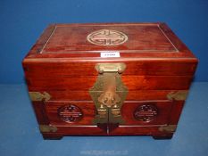 A large Oriental jewellery casket having brass fittings and lift up lid with three internal drawers,