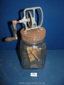 A glass butter Churn with wooden paddles, metal lid, (3 imperial quarts) 14" high.