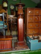 A heavy Mahogany lamp table/jardinere stand having a chamfered square pillar with turned and
