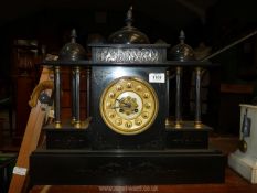 A 19th Century Blackslate palladium style Mantle Clock with bronze and gilt column and panel detail,