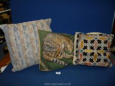 Three tapestry cushions, one of a cat.