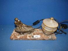 An Art Deco style desk Lamp having a marble base and a spelter figure of a fisherman and with