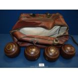 A brown carrying case with four bowling Balls by Taylor Lidnoid, size 3.