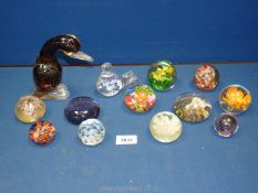 Thirteen miscellaneous paperweights including a bird and a duck.