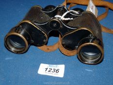 A pair of brass Busch Dienstglas 6 x 30m Binoculars with leather strap.