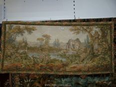 A bordered polychrome wall hanging depicting an attractive pastoral river landscape with a timber