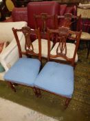 A set of four Mahogany framed Dining Chairs having delicate fretworked and carved detailed backs,