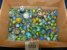A quantity of marbles, some large.