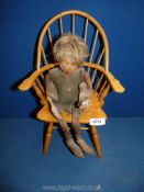 A miniature stickback Chair, 15" high together with a hand made old metal dressed doll.