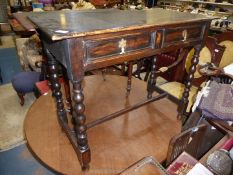 A dark stained Oak circa 1900 side Table having a pair of frieze drawers with brass drop handles