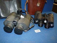 A pair of brown leather cased Carl Zeiss binoculars 10 x 50 w and a pair of Pentax 10 x 50