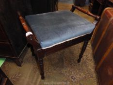 An Edwardian Mahogany framed Piano Stool standing on turned legs and the dark turquoise