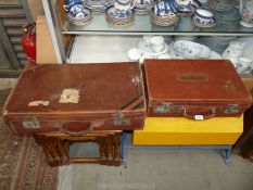 Two leather suitcases; the larger one having 'PN' stamped on the lid 26" x 14 1/2" x 7",