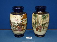 A pair of Japanese vases with scenes of figures in a garden with blossoms,