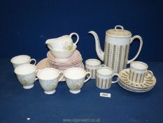 A Susie Cooper part tea set in 'Persia' pattern to include teapot, three cups, five saucers,