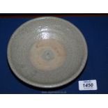 A small Celadon glazed bowl in characteristic fashion of the Sawankhalok dynasty,