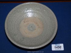 A small Celadon glazed bowl in characteristic fashion of the Sawankhalok dynasty,