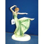 A continental china figure of an Art Deco lady dancing in green dress, possibly German,