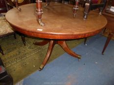 A circa 1900 circular snap-top Mahogany breakfast Table standing on a turned pillar with four swept