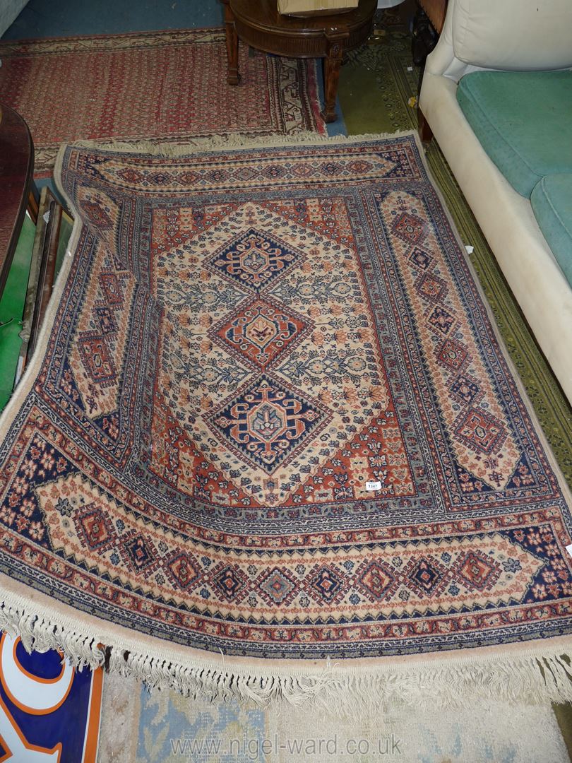 A hand-made cream and brown bordered, patterned and fringed Keshan Carpet, 83" x 55".