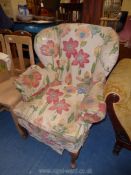 An elegant early 19th century style wing Fireside Chair standing on cabriole front legs and having