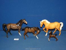 Four Beswick horses including Palomino (chip to ear,) Bay foals, plus another.