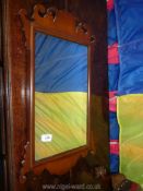 An early reproduction of a Georgian fretworked perimeter Mahogany framed wall Mirror,