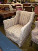 A low Edwardian wing fireside Armchair having peach/grey and beige fabric loose cover and of