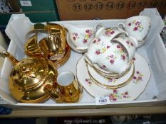 A gold Royal Worcester tea set and a Queen Anne floral part tea set, including six cups,