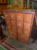 A Satinwood and Mahogany spice Storage Chest having twelve small and four large drawers,