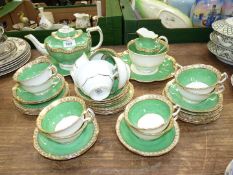 A tea set in green with gilt coloured edges by George Jones & Sons to include; teapot, sugar bowl,