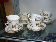 A part Royal Worcester Teaset in cream with brown and gilt fruit decoration comprising of six cups