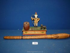 A vintage cast metal 'trick dog' Money Box, plus an Australian wooden throwing club.