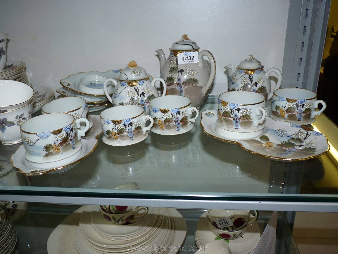 An oriental Teaset with six cups and five saucers, small teapot, sugar bowl and lidded milk jug.