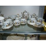 An oriental Teaset with six cups and five saucers, small teapot, sugar bowl and lidded milk jug.