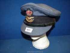 An original Royal Air Force Officers cap and cloth badge, purchased from Moss Bro's, size 6 7/8".