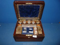 A wooden vanity box lined with blue velvet having a secret drawer,