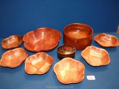 A circular fruit bowl, a mixed wood bowl with six smaller bowls and a lacquered box and lid.