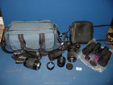 A pair of Tasco Binoculars and a Minolta SLR X-700 camera with case.