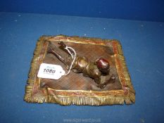 A cold painted bronze figure of a young Arab boy on a carpet, 7 1/2" x 6 1/2",