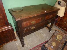 An Oak Buffet table/Sideboard standing on turned legs united by an ''H'' stretcher and having one