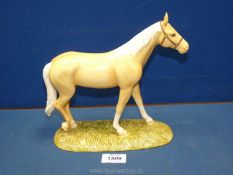 A boxed Royal Doulton 'Palomino' from the 'Horse and Pony collection' 10½" wide x 8½" tall.