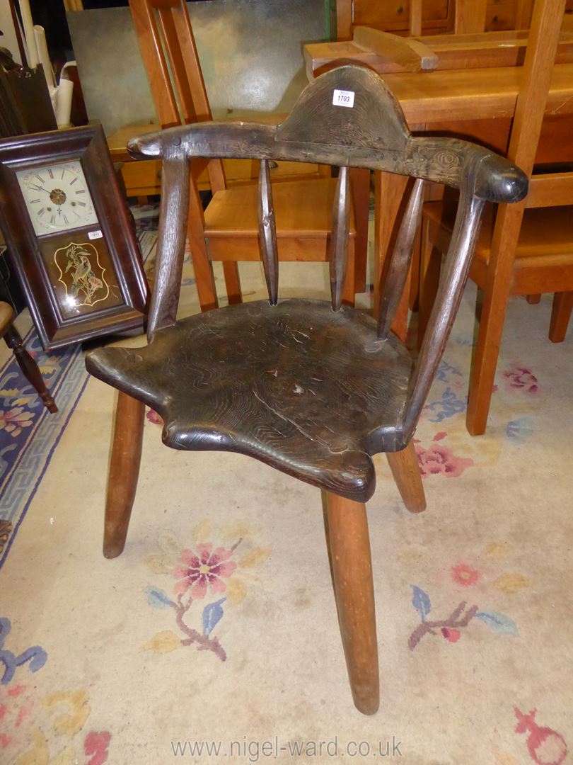 A collectable early Primitive and rustic comb back Chair having a solid Elm shaped seat,