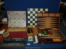 A cased set of Backgammon, a Victory mouth organ, playing cards, Scrabble, Chess, Dominoes, etc.