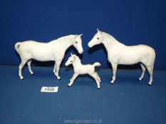 Three Royal Doulton dapple grey ponies, one being a foal (one with a small chip to ear.