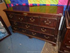 A Georgian Oak Chest having five true drawers and four false drawers to the locker top,