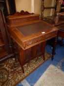 A circa 1910/20 Satinwood Davenport having a lockable stationary storage compartment to the top,
